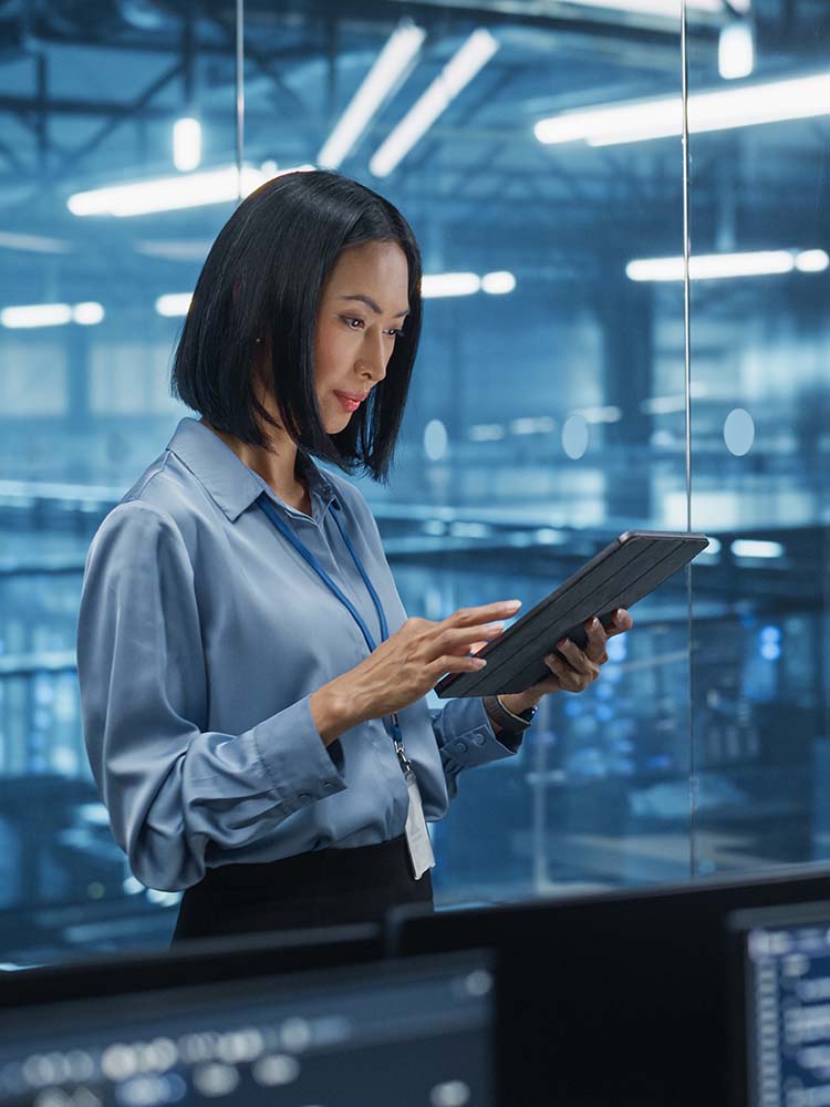 Women working on a tablet with a server behind her.